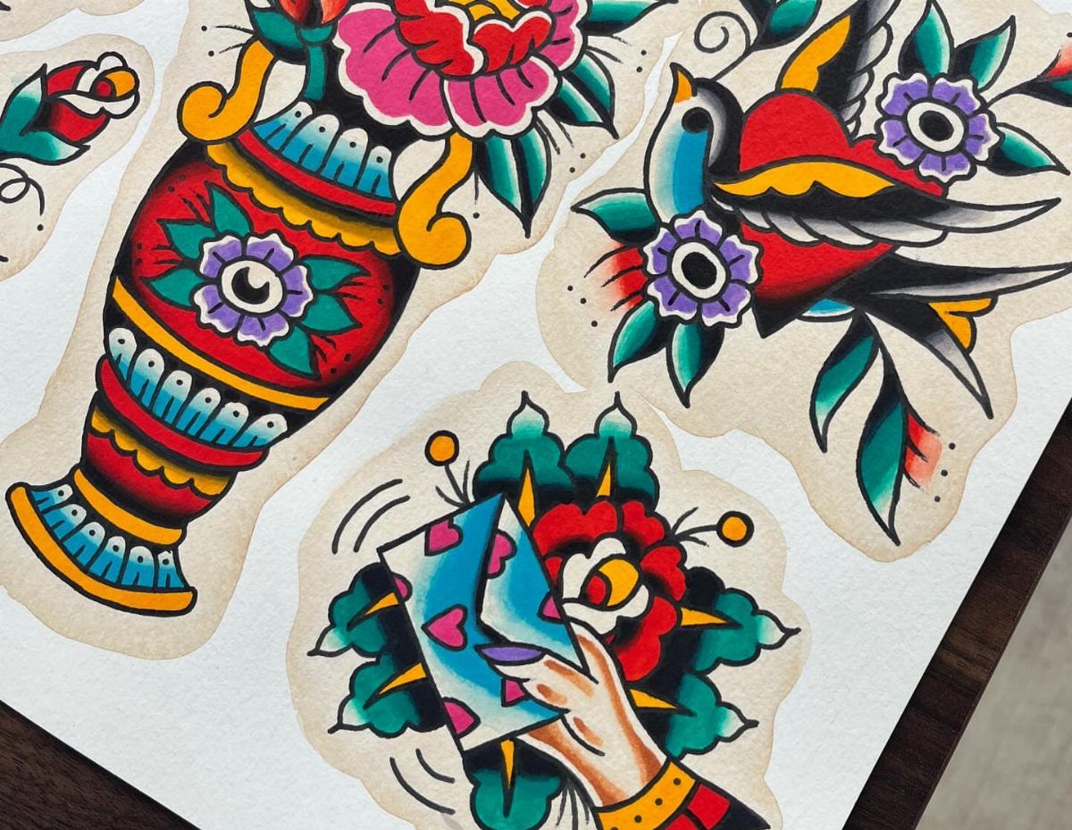 American traditional tattoo flash art designs featuring a vase, a swallow, and a hand on paper.