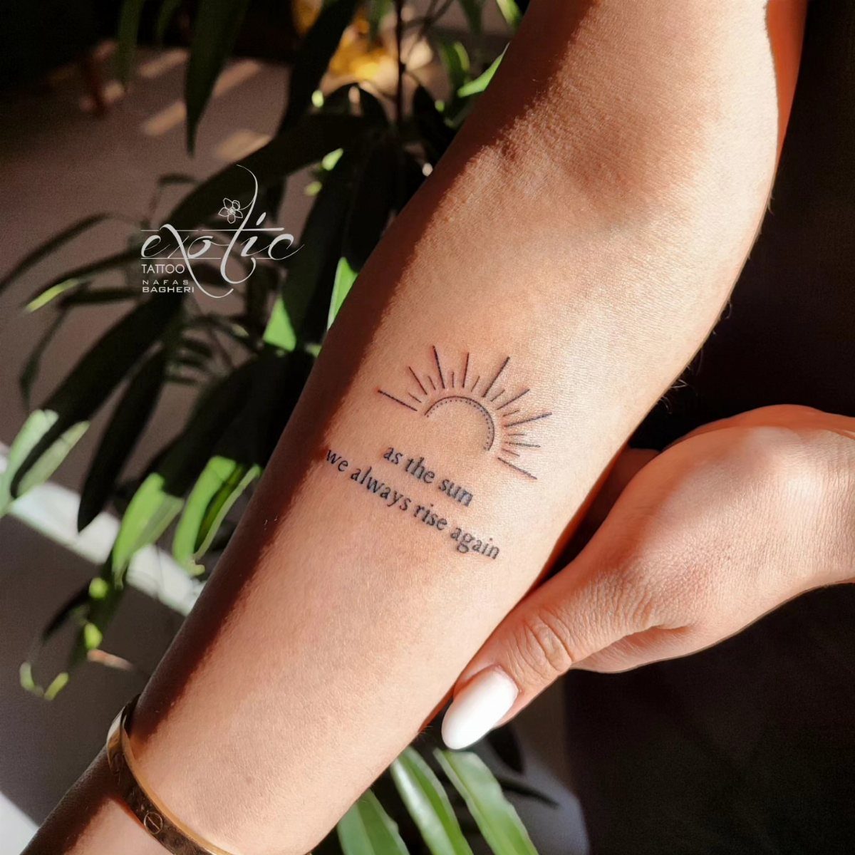 12 Easy Tattoo Drawings For Beginners, From Hearts to Tribal Flash 4 A minimalist sun tattoo with radiating lines and text on a person's forearm.