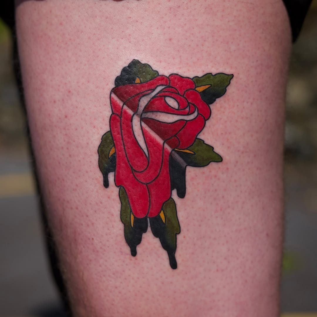 12 Easy Tattoo Drawings For Beginners, From Hearts to Tribal Flash 6 A traditional red rose tattoo with green leaves on a person's skin.