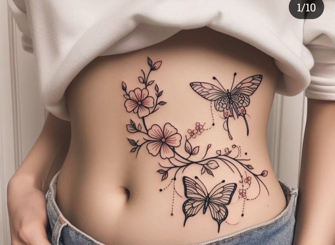 A woman's stomach decorated with a large tattoo of pink flowers, vines, and two butterflies.