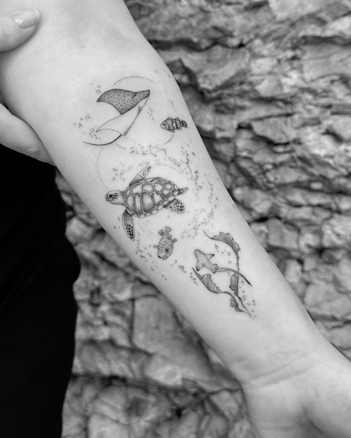 10 Ocean Themed Tattoos: From Fine Line Turtles to Black and Grey Mantas 7 Fine line black ink tattoo of a sea turtle, manta ray, and fish on a forearm.