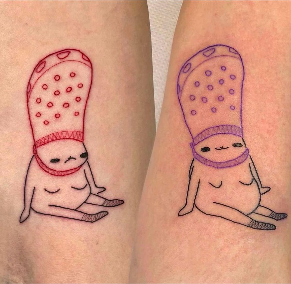 Two minimalist character tattoos on skin, one sad with red outlines and one happy with purple outlines.
