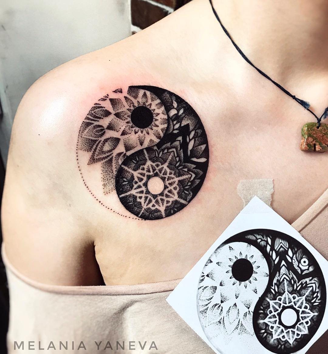 A mandala-style yin yang tattoo with intricate geometric patterns on a person's shoulder.