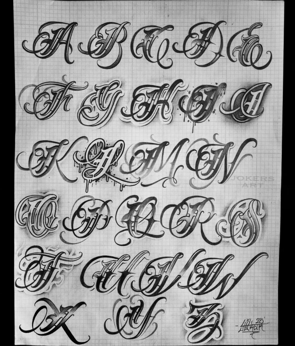 Ornate black ink calligraphy alphabet with decorative flourishes drawn on grid paper.