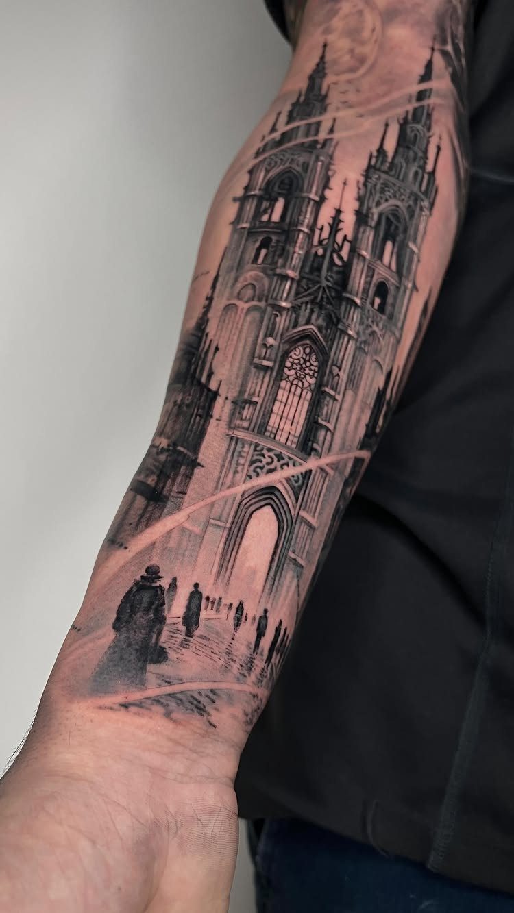A detailed black and grey Gothic cathedral tattoo covering a person's entire forearm.