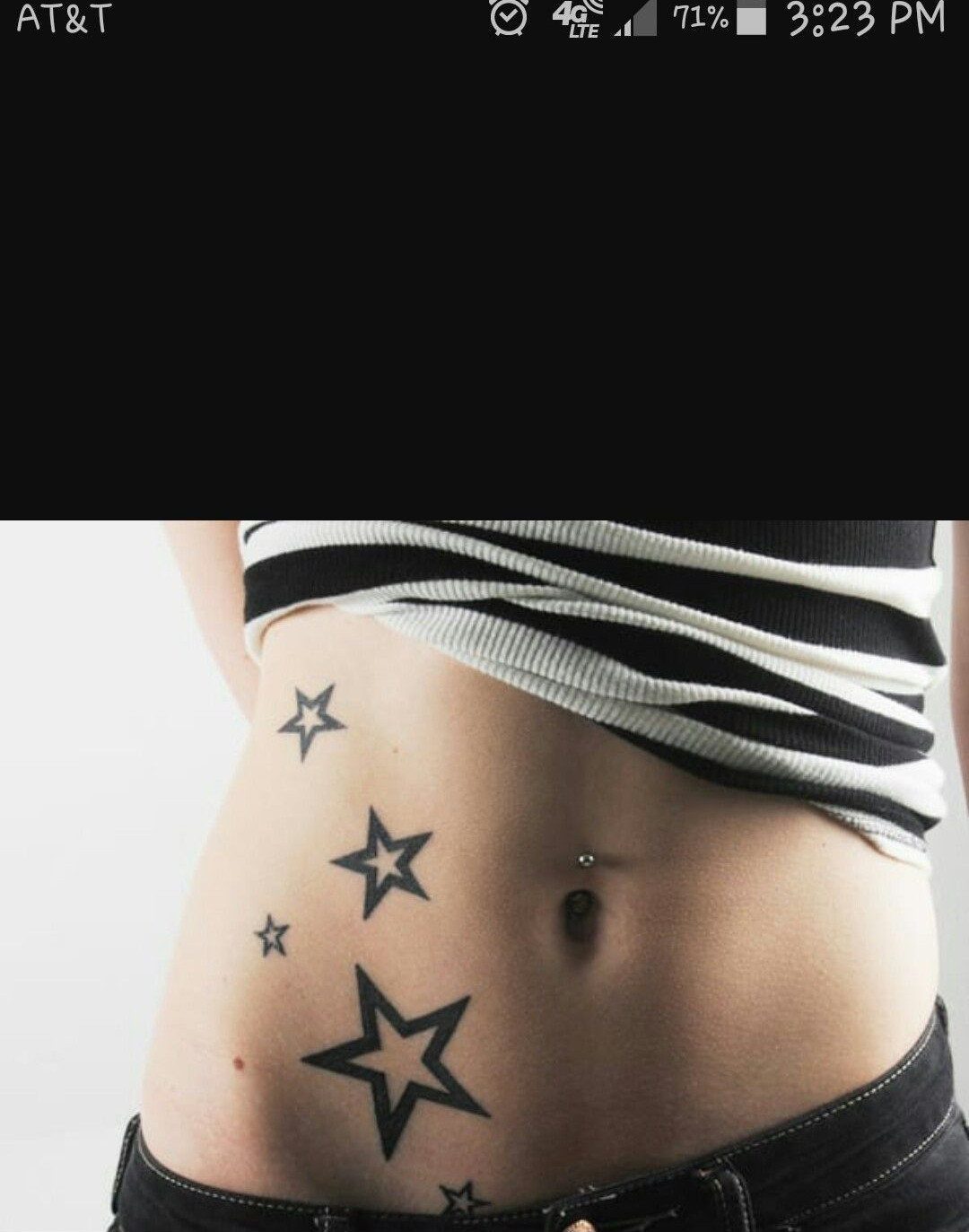 Black ink star tattoos of different sizes scattered across a person's waist and abdomen.