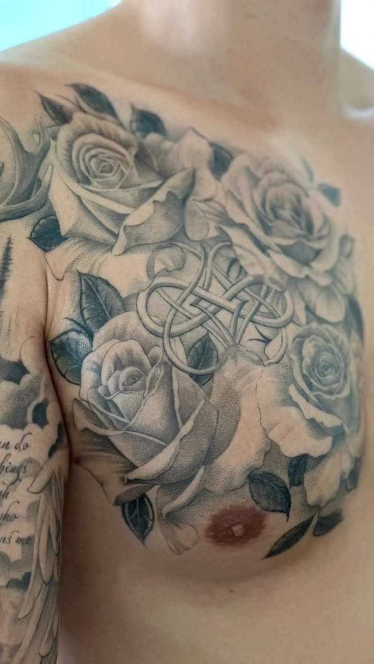 22 Tattoo Pattern Floral Ideas for Arms, Ribs & Full Sleeves 1 Large black and grey rose tattoos with knotwork patterns on a person's chest.