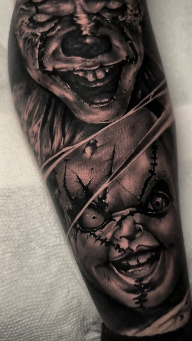 A detailed black and grey realism tattoo of the horror character Chucky's scarred face.