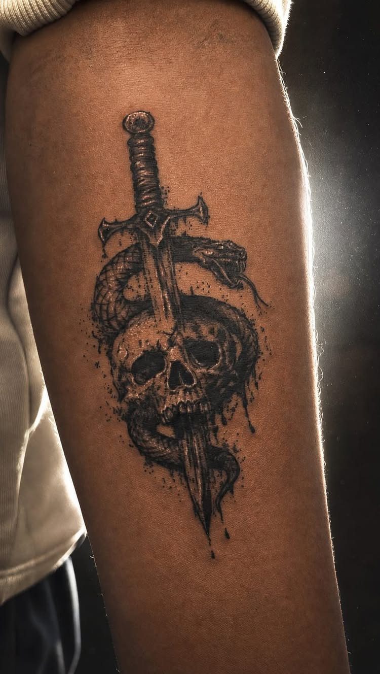 A black ink tattoo of a skull, dagger, and coiled serpent on a person's arm.